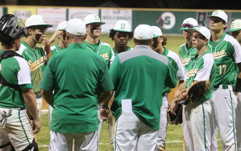 Suwannee’s baseball team huddles up postgame to listen to head coach Justin Bruce after losing to West Nassau 14-6 on Tuesday. (PAUL BUCHANAN/Special to the Reporter)