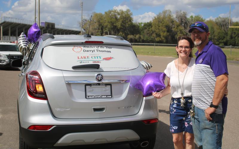 Columbia High welding teacher Darryl Thomas and his wife, Jan, stand with their brand new Buick Encore, a prize Thomas won for being named the Columbia County School District’s Teacher of the Year. (TONY BRITT/Lake City Reporter)