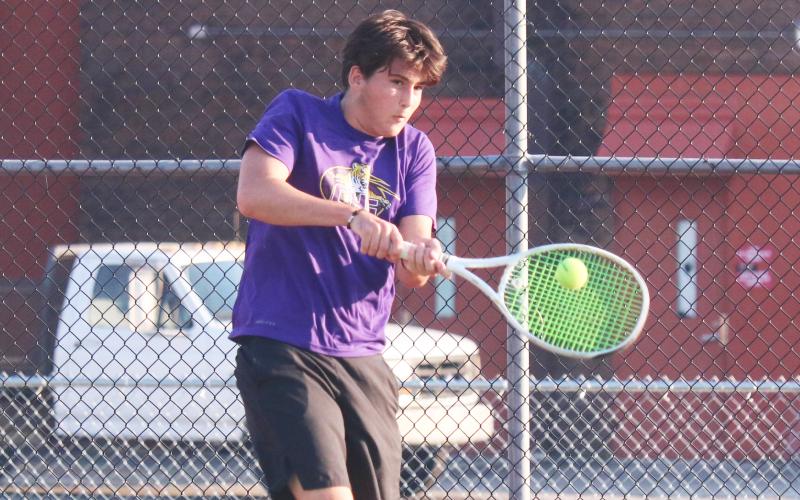 Columbia’s Aidan Boudreau returns a shot against Fleming Island’s Williams Hughes on Wednesday. (JORDAN KROEGER/Lake City Reporter)