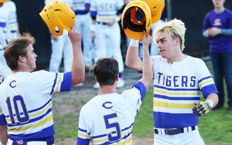Columbia third baseman Hayden Gustavson (right) celebrates at home plate with first baseman Brent Howard (10) and outfielder Matthew Dumas (5) after hitting a 3-run home run against Valwood in the first inning Monday night. (JORDAN KROEGER/Lake City Reporter)