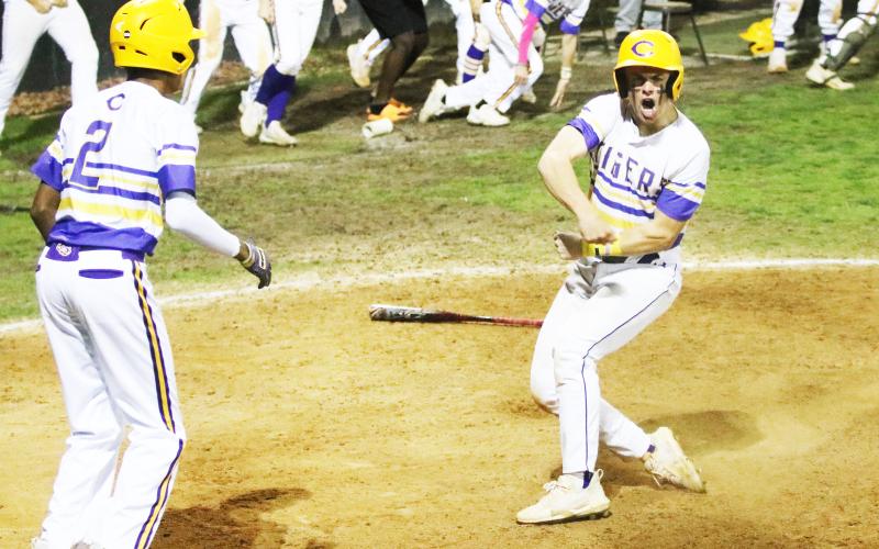 Columbia’s Hayden Gustavson celebrates after scoring the game-winning run against North Florida Christian on Friday night. (JORDAN KROEGER/Lake City Reporter)