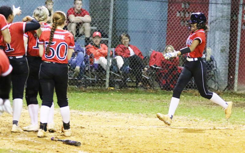 Fort White outfielder Morgan Kelly is all smiles as she heads toward home plate after hitting a home run against Lafayette on Thursday night. (MORGAN MCMULLEN/Lake City Reporter)