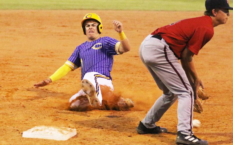 Columbia third baseman Hayden Gustavson slides into third base safely against Baker County on Tuesday night. (MORGAN MCMULLEN/Lake City Reporter)