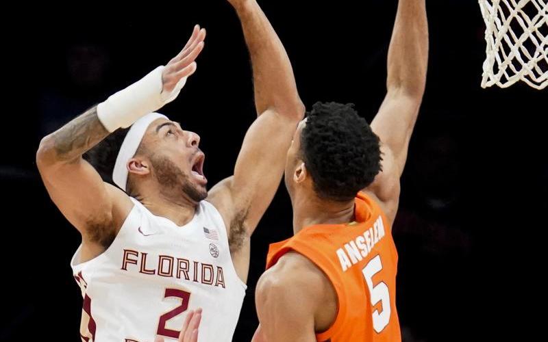 Florida State's Anthony Polite (2) shoots against Syracuse's Frank Anselem (5) during Wednesday's game of the Atlantic Coast Conference men's tournament on Wednesday in New York. (JOHN MINCHILLO/Associated Press)