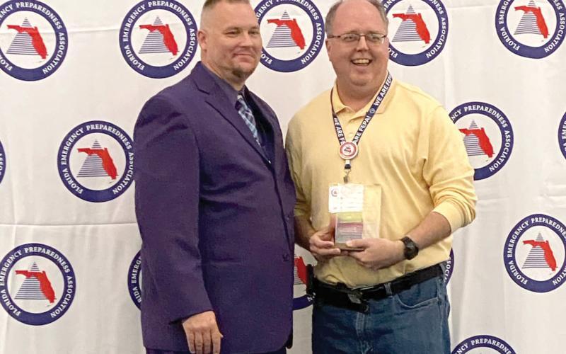 Shayne Morgan (right) was honored as the Florida Emergency Preparedness Association’s Chad Reed Emergency Management Professional of the Year in February. (COURTESY)