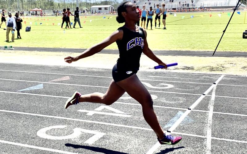 Columbia’s Stacy White crosses the finish line in the 4x100 relay at the Creekside Invitational on Saturday. (DYLAN ASPENWALL/Special to the Reporter)