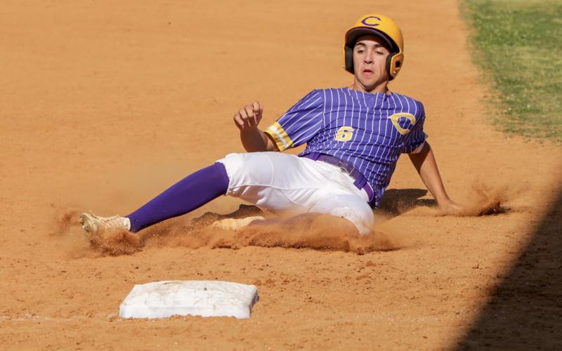 Columbia's Grant Bowers slides safely into third base during Monday's game against Bishop Kenny (BRENT KUYKENDALL/Lake City Reporter)