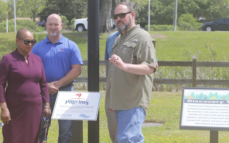 Pilgrim’s Pride’s Brent Lang (right) speaks at Wednesday’s unveiling of Discovery Trail as Suwannee River Regional Library System director Betty Lawrence (left) listens. (JAMIE WACHTER/Lake City Reporter)