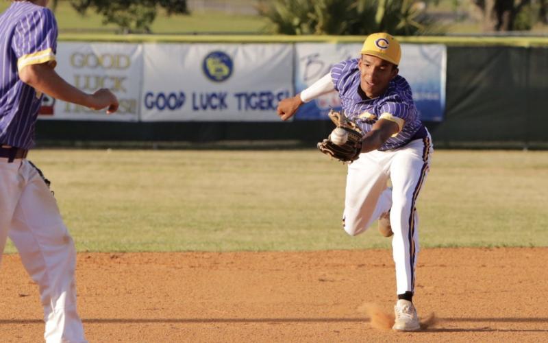 Columbia second baseman Brayden Thomas just misses a ball through the infield during Friday night’s game against Buchholz. (BRENT KUYKENDALL/Lake City Reporter)