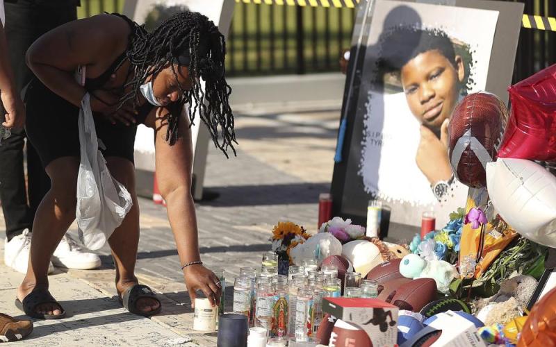 Family and friends of Tyre Sampson leave items during a vigil in front of the Orlando Free Fall drop tower on March 28. (STEPHEN M. DOWELL/Orlando Sentinel/Associated Press)