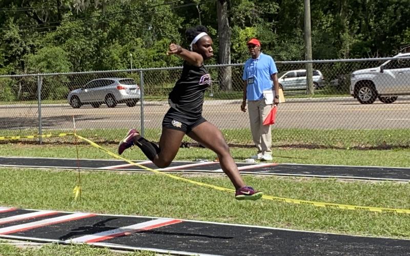 Columbia’s Stacy White won the District 3-3A title in the triple jump on Saturday. (DYLAN ASPENWALL/Special to the Reporter)
