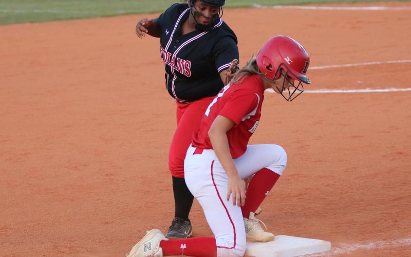 Lafayette’s Jaley Moseley beats a tag from Fort White third baseman N’Coreyia Atkins during Tuesday’s game. (JORDAN KROEGER/Lake City Reporter)