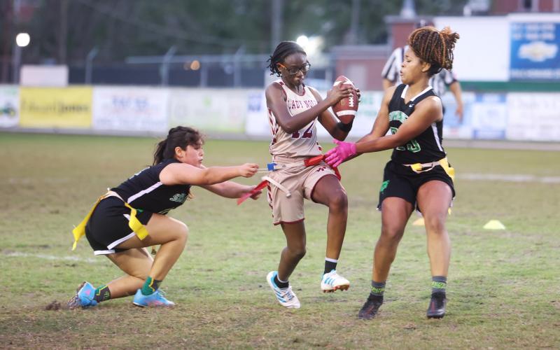 Suwannee’s Amyrah Jones (right) pulls the flag of Florida High’s Rachel White on Wednesday night. (PAUL BUCHANAN/Special to the Reporter)