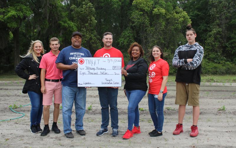 Bobby Brewin (center) with the Lake City Target Distribution Center presents an $8,000 check to Adee Farmer for the Pathways Academy garden. Also present were Dianna Swisher (from left), Brandon Ray, Pathways Principal Makeba Murphy, Nicole Robertson and Joseph Lee Pendleton. (TONY BRITT/Lake City Reporter)