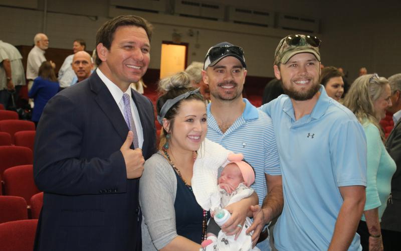 Chance and Chelsie Windham took their three-week-old daughter, Sadie June, to meet Gov. Ron DeSantis on Tuesday during his Jasper visit. Also pictured is Josh Smith (right), a family member. (TONY BRITT/Lake City Reporter)