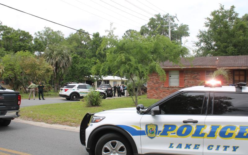 Law enforcement officers surround a residence on the north side of Lake City on Wednesday afternoon. Katrell Hubbard had eluded  custody since March 30 after he fled on foot following a traffic stop. (TONY BRITT/Lake City Reporter)