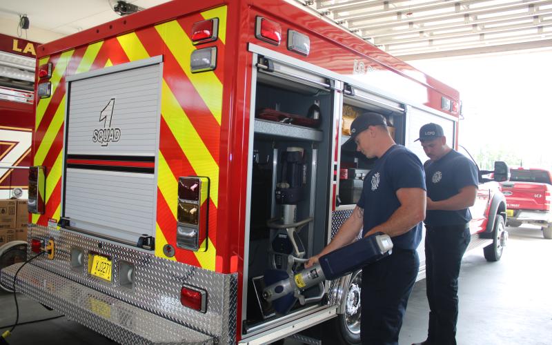 Hunter Anderson (from left) and Adam Lockwood, Lake City Fire Department firefighters, inventory extrication equipment that is carried in the department’s new Quick Response Truck on Wednesday afternoon. (TONY BRITT/Lake City Reporter)