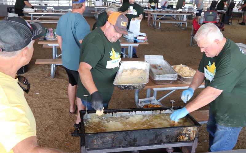 COURTESY A pair of volunteers work on frying up fish during the 11th annual Fins and Pins fundraiser on Saturday. Fins and Pins raised roughly $40,000 during the fish fry and bowling outing. (COURTESY)