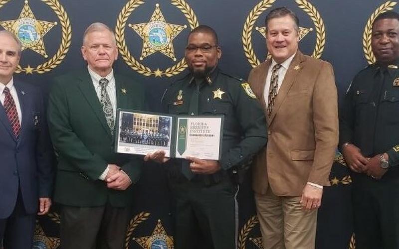 Columbia County Sheriff’s Office Lt. Martin Lee graduated from the Florida Sheriffs Institute Commanders Academy on Friday. Pictured with Lee (center) are Florida Sheriffs Association Director Steve Casey (from left), FSA President Sheriff Bobby McCallum of Levy County, Sheriff Mark Hunter and Sheriff Morris Young of Gadsden County. (COURTESY)