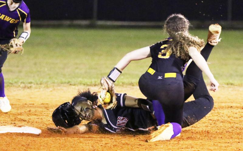 Fort White’s Ciara Byrd is tagged out by Bell’s Michelle Heilig as she tries to steal second base on Thursday night. (MORGAN MCMULLEN/Lake City Reporter)