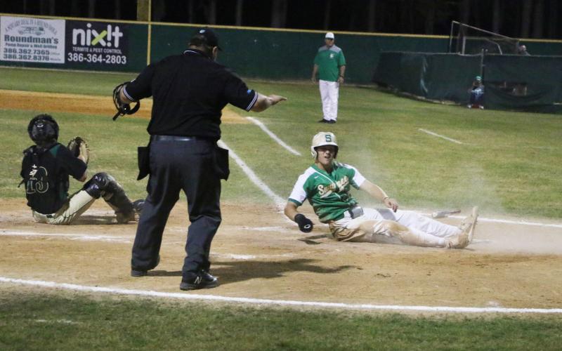Suwannee’s Josh Fernald slides safely into home plate to score against Lincoln in the fifth inning on Friday. (MORGAN MCMULLEN/Lake City Reporter)