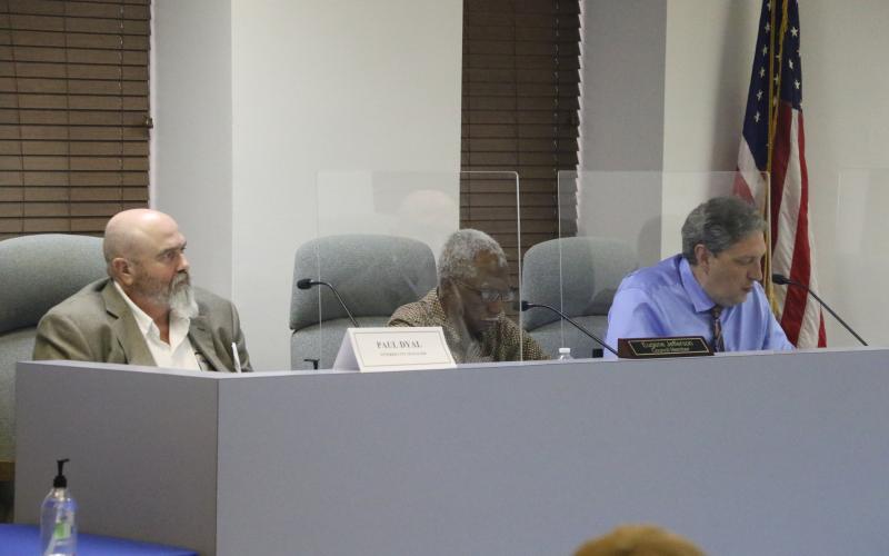 Councilman Todd Sampson (right) listens alongside fellow councilman Eugene Jefferson and interim city manager Paul Dyal during Monday's city council meeting (MORGAN MCMULLEN/Lake City Reporter)