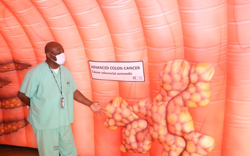 John Young Jr., a registered nurse, points out how advanced colon cancer could look when attached to the inner wall of the colon. (MORGAN MCMULLEN/Lake City Reporter)