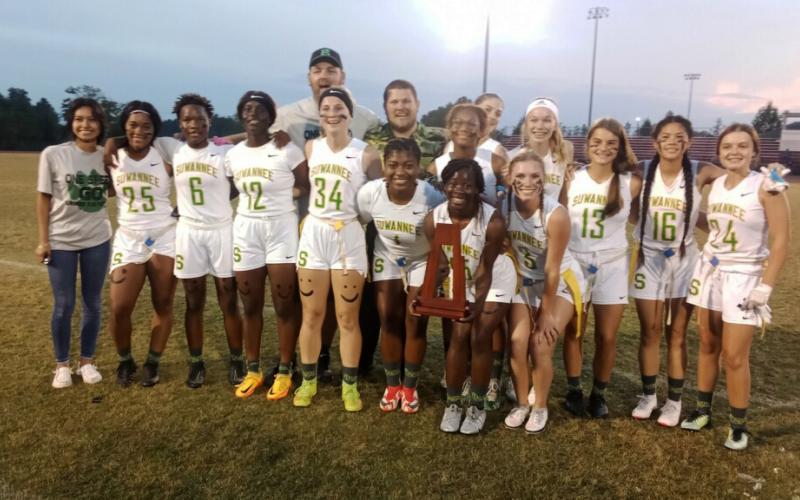 Suwannee’s flag football team celebrates with the District 2-1A trophy after defeating Florida High on Friday night. (CONCEPCION LEDEZMA/Special to the Reporter)