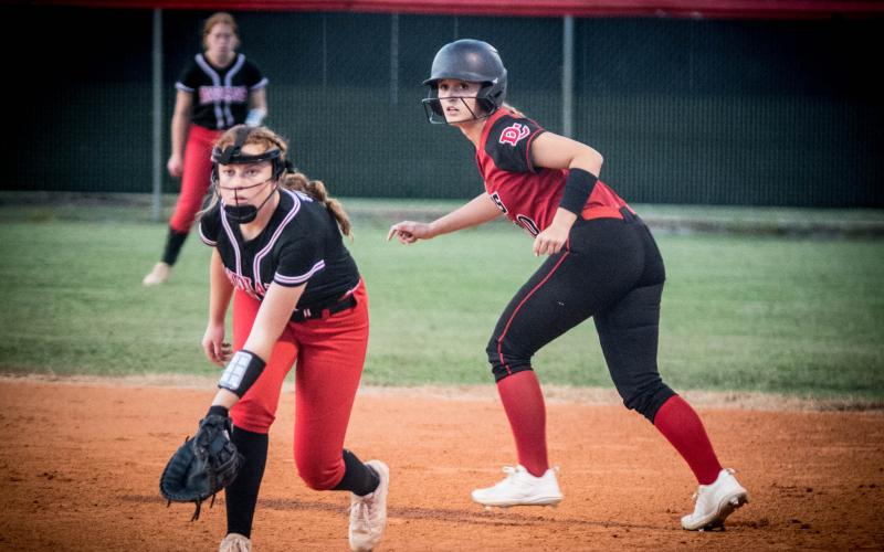 Fort White first baseman Hannah Brown tries to hold a Dixie County runner at first base during the Indians’ 2-1 loss Thursday night. (CHRISTINA FEAGIN/Special to the Reporter)