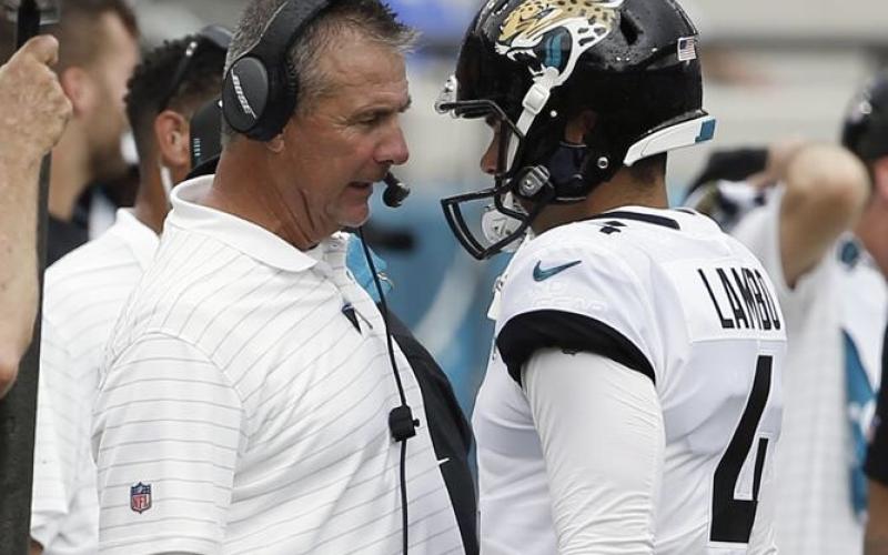 Jacksonville Jaguars head coach Urban Meyer (left) talks with place kicker Josh Lambo after Lambo missed his second field goal against the Denver Broncos on Sept. 19, 2021, in Jacksonville. (AP FILE)