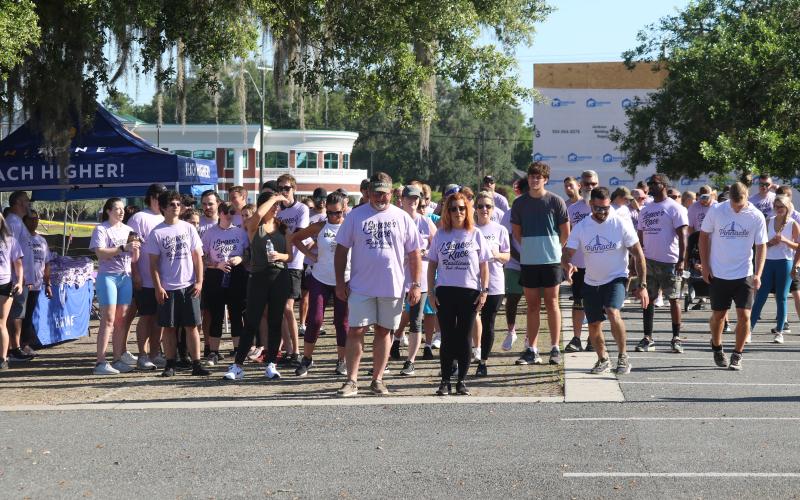 Grace Duncan’s parents Burt and Cissy (center) help lead the start of the second Grace’s Race 5K Saturday. (JAMIE WACHTER/Lake City Reporter)