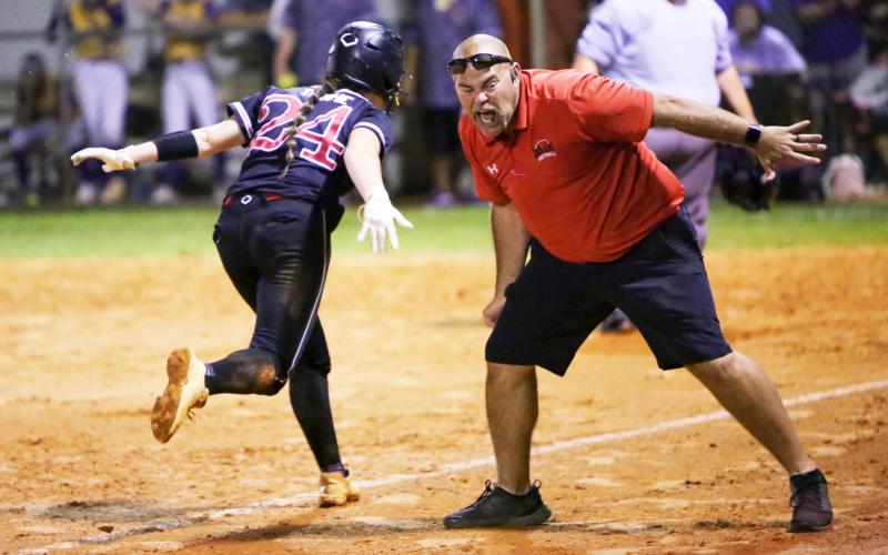 Fort White co-head coach Chad Padgett screams as he congratulates Kadence Compton on her way home on a sixth-inning home run against Union County in the Region 3-1A championship game on Tuesday night. (BRENT KUYKENDALL/Lake City Reporter)