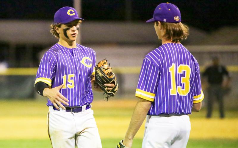 Columbia pitcher Truitt Todd (left) shakes hands with pitcher Philip Maddox as he exits the game in the seventh inning of Tuesday’s Region 1-5A quarterfinal against St. Augustine. (BRENT KUYKENDALL/Lake City Reporter)