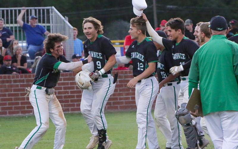 Suwannee’s Tyson Greene is congratulated by his teammates after hitting a two-run home run against Baker County in the fourth inning Wednesday in the Region 1-4A quarterfinals at Booster Field. (BRENT KUYKENDALL/Lake City Reporter)
