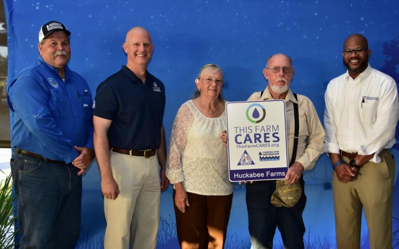 Suwannee County’s Alvin and Nancy Huckabee (center) received a ‘This Farm CARES’ designation on May 5 from Suwannee River Water Management Director Hugh Thomas (from left), Florida Farm Bureau President Jeb S. Smith and Andra Johnson, the UF/IFAS dean of extension and director of the Florida Cooperative Extension Service.