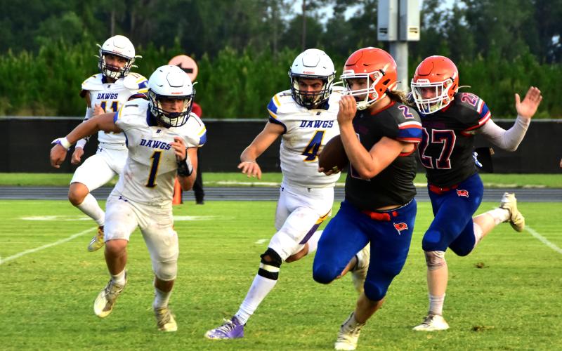 Branford running back Caden Coker rushes up the field against Bell during their spring jamboree on Tuesday. (ROB WOLFE/Special to the Reporter)