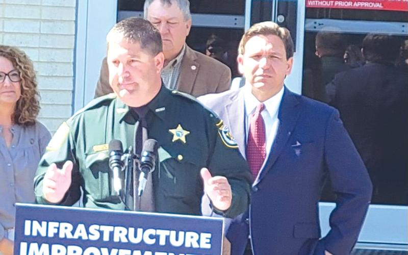 Lafayette County Sheriff Brian Lamb (left) speaks in front of Gov. Ron DeSantis on Wednesday. (COURTESY)