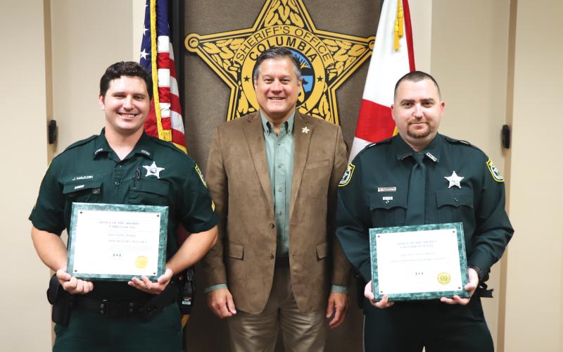 Corporal James Maulden (left) and Detention Officer Mark Collins (right) received ‘Lifesaving Medals’ from Sheriff Mark Hunter on Wednesday. (COURTESY)