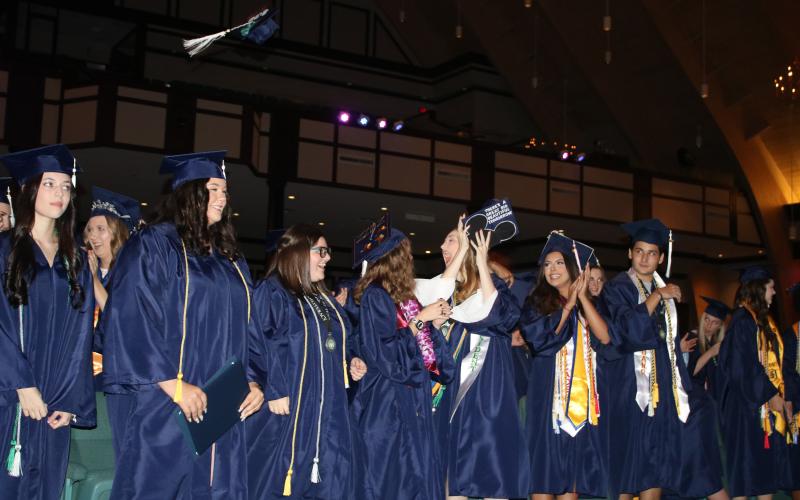 Belmont Academy Class of 2022 students react after turning their tassels and becoming graduates Friday night at Christian Fellowship Church. (TONY BRITT/Lake City Reporter)