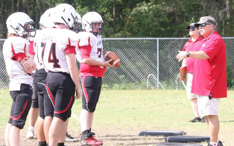 Fort White head coach Lee Dorsett instructs his offensive line during Monday’s practice. (MORGAN MCMULLEN/Lake City Reporter)