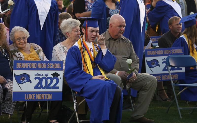 Branford salutatorian Luke Norton wipes away a tear after presenting loved ones with a flower during commencement exercises Friday night at Buccaneer Stadium. (MORGAN MCMULLEN/Lake City Reporter)