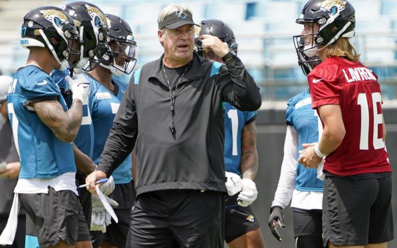 Jacksonville Jaguars head coach Doug Pederson (center) directs practice on Monday in Jacksonville. At right is quarterback Trevor Lawrence. (JOHN RAOUX/Associated Press)