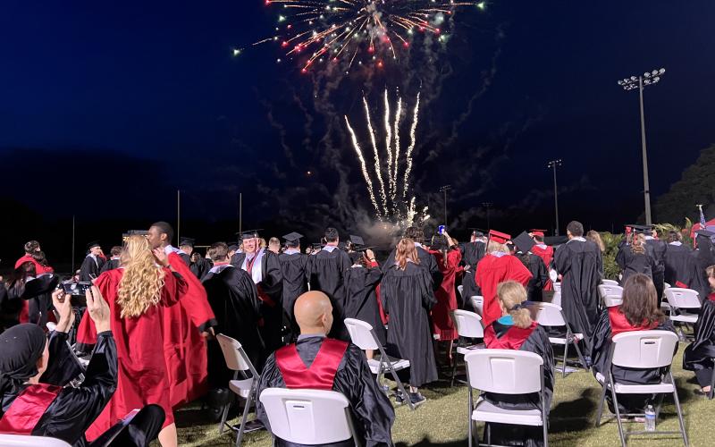 Fort White graduates watch a fireworks display at the end of commencement exercises Friday night at Arrowhead Stadium. (RAY CARPENTER/Special to the Reporter)