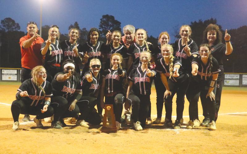 Fort White’s softball team poses with the District 6-1A trophy after defeating Branford 11-0 on Thursday. (MORGAN MCMULLEN/Lake City Reporter)