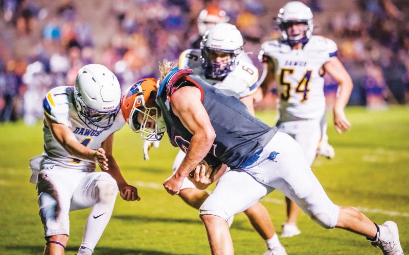 Branford running back Caden Coker meets a Bell defender during the teams’ matchup last September. The teams will face off again this fall on Sept. 9. (BRIAN LEWIS/Special to the Reporter)