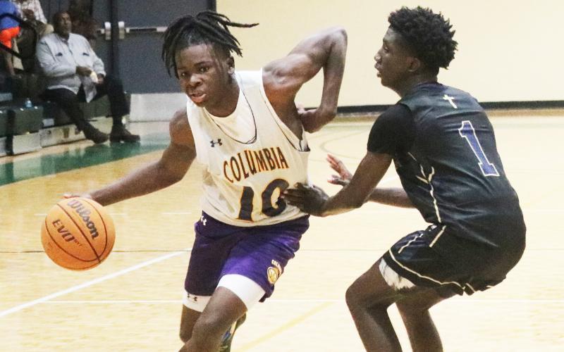Columbia guard Isaac Broxey drives to the basket against St. John Paul II during the team’s shot clock league on June 8 at FGC. (JORDAN KROEGER/Lake City Reporter)