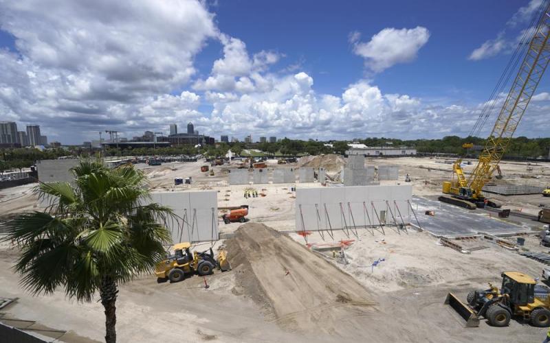 Workers continue construction of the Jacksonville Jaguars Sports Performance Center on May 31 in Jacksonville. The center, scheduled to be completed in 2023, includes nearly 130,000 square feet of space that will house new meeting rooms, weight rooms, locker rooms and practice fields. (JOHN RAOUX/Associated Press)