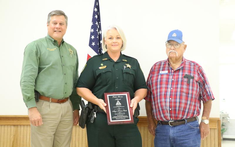 Maj. Katina Dicks (center) accepts her award at Tuesday’s Columbia County Farm Bureau dinner. (MORGAN MCMULLEN/Lake City Reporter)