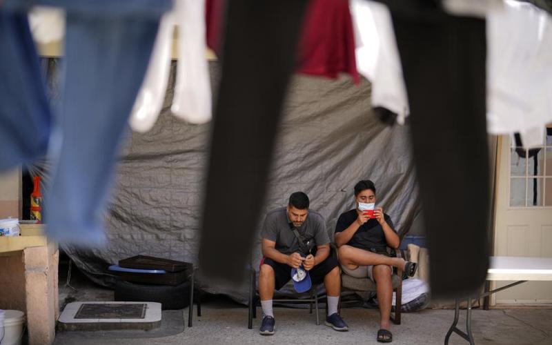 Two men from Nicaragua wait to apply for asylum in the United States Thursday, June 30, 2022, at a shelter for migrants in Tijuana, Mexico. (GREGORY BULL/Associated Press)