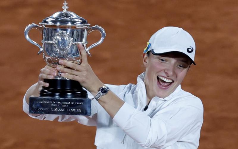 Iga Swiatek celebrates with the cup after defeating Coco Gauff in the French Open final at the Roland Garros Stadium on Saturday in Paris. Swiatek won 6-1, 6-3. (JEAN-FRANCOIS BADIAS/Associated Press)